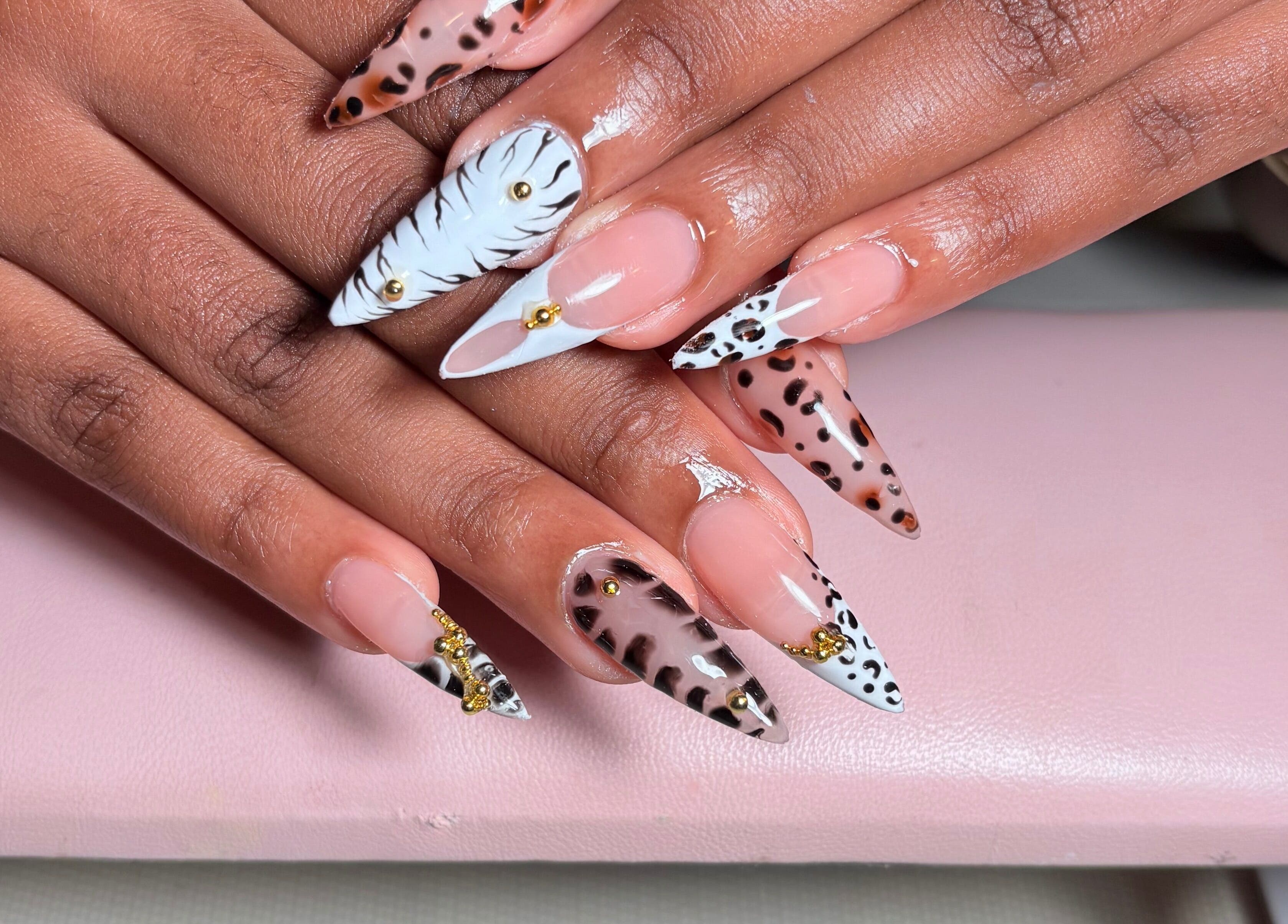 Bold animal print nails at KuredKlaws, Ottawa, Ontario, CA showcase unique, intricate designs.