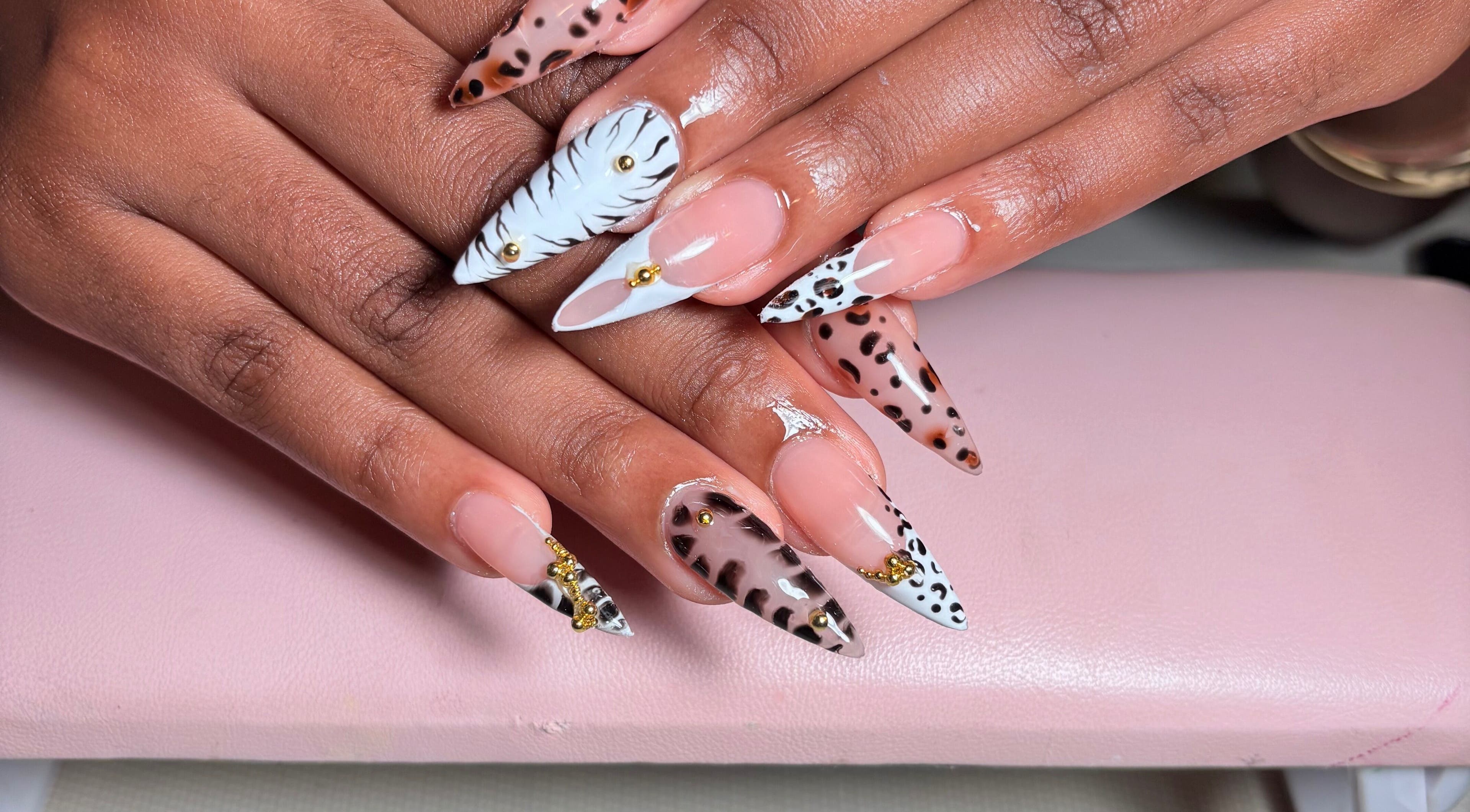 Bold animal print nails at KuredKlaws, Ottawa, Ontario, CA showcase unique, intricate designs.