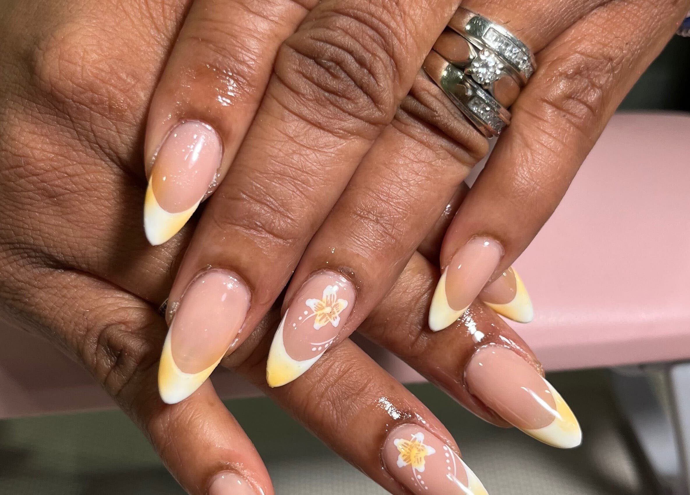 French tip nails with floral design at KuredKlaws, Ottawa, Ontario, CA. Showcase of professional nail artistry.