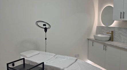 Tranquil treatment room at H.astudiosx in Carlton, England, GB featuring a massage bed and ambient lighting.