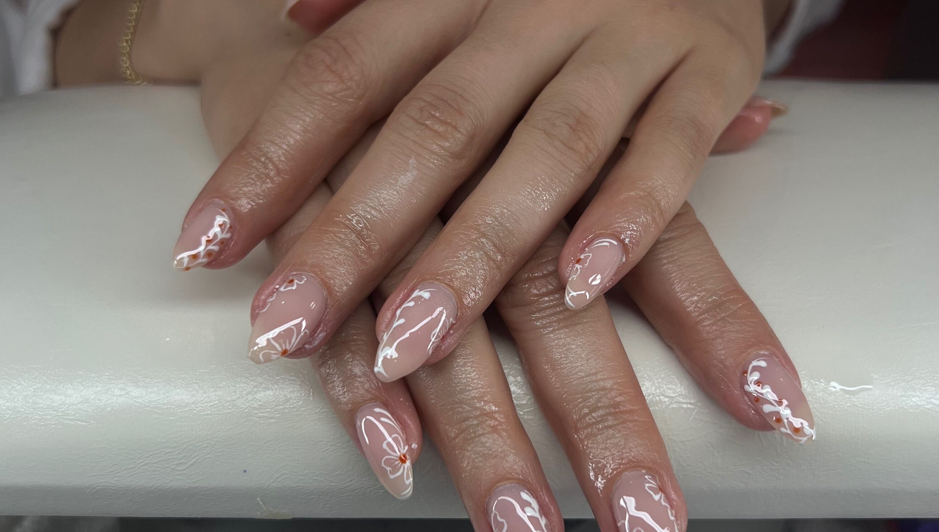 Elegant nail art at Puff Polish in Ottawa, Ontario, CA, featuring intricate design on manicured hands.