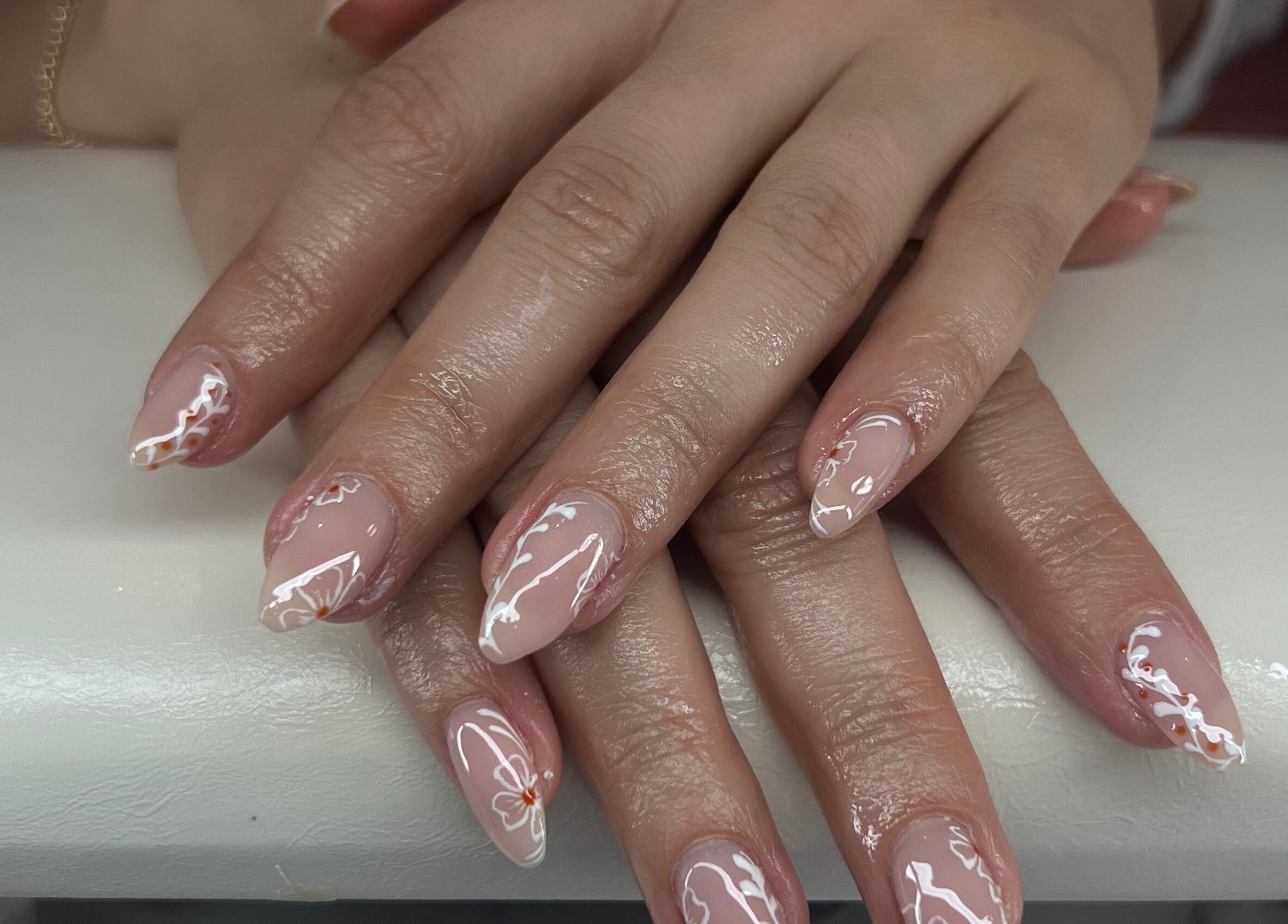Elegant nail art at Puff Polish in Ottawa, Ontario, CA, featuring intricate design on manicured hands.