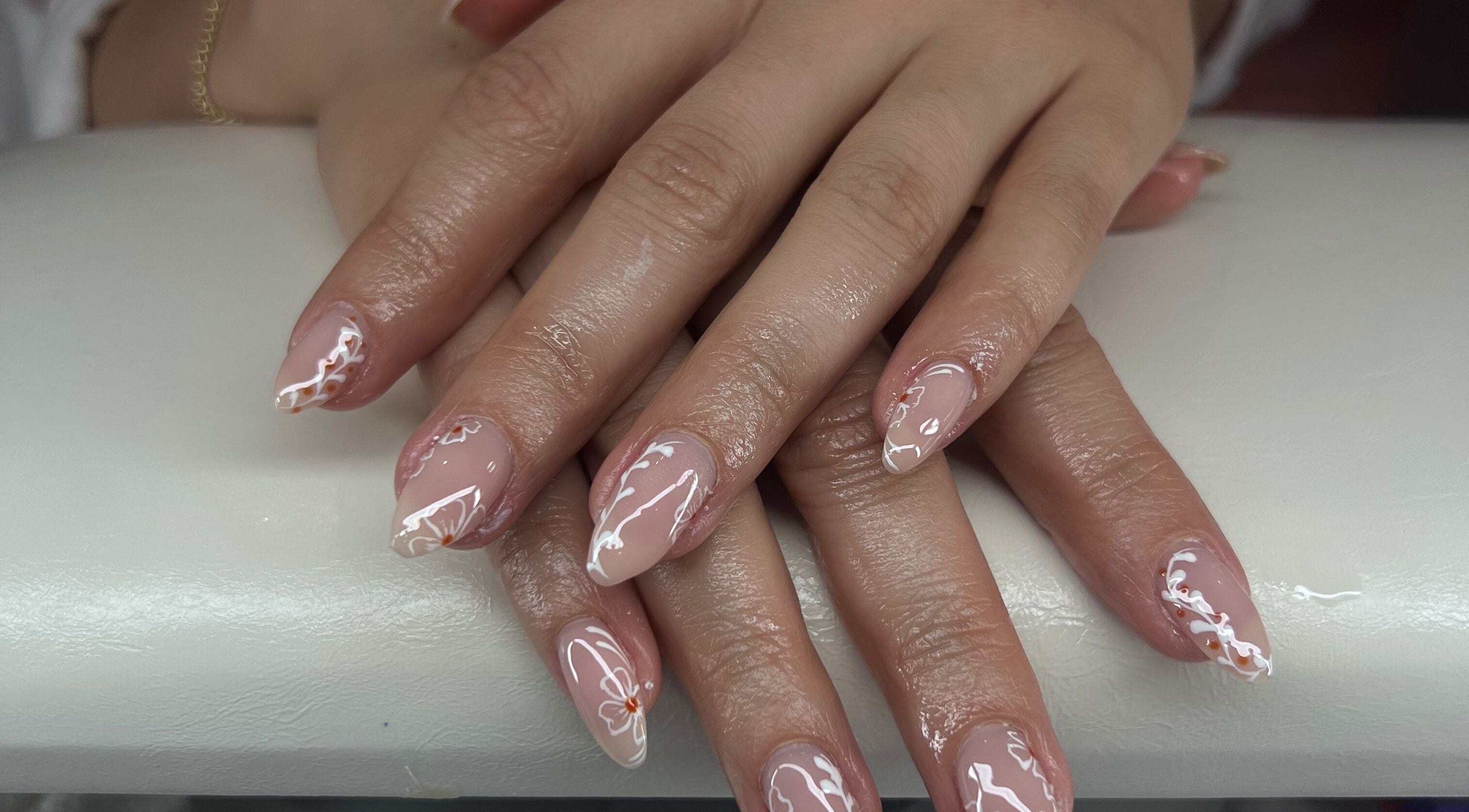 Elegant nail art at Puff Polish in Ottawa, Ontario, CA, featuring intricate design on manicured hands.
