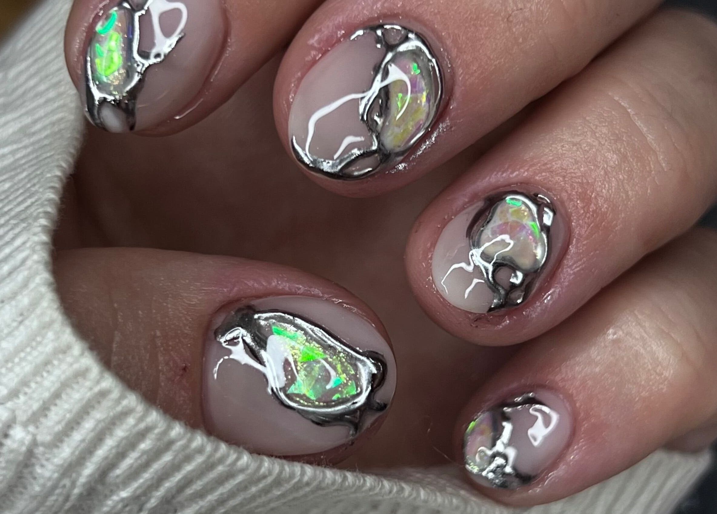 Intricate opal nail art at Puff Polish in Ottawa, Ontario, CA, showcasing shimmering design detail.
