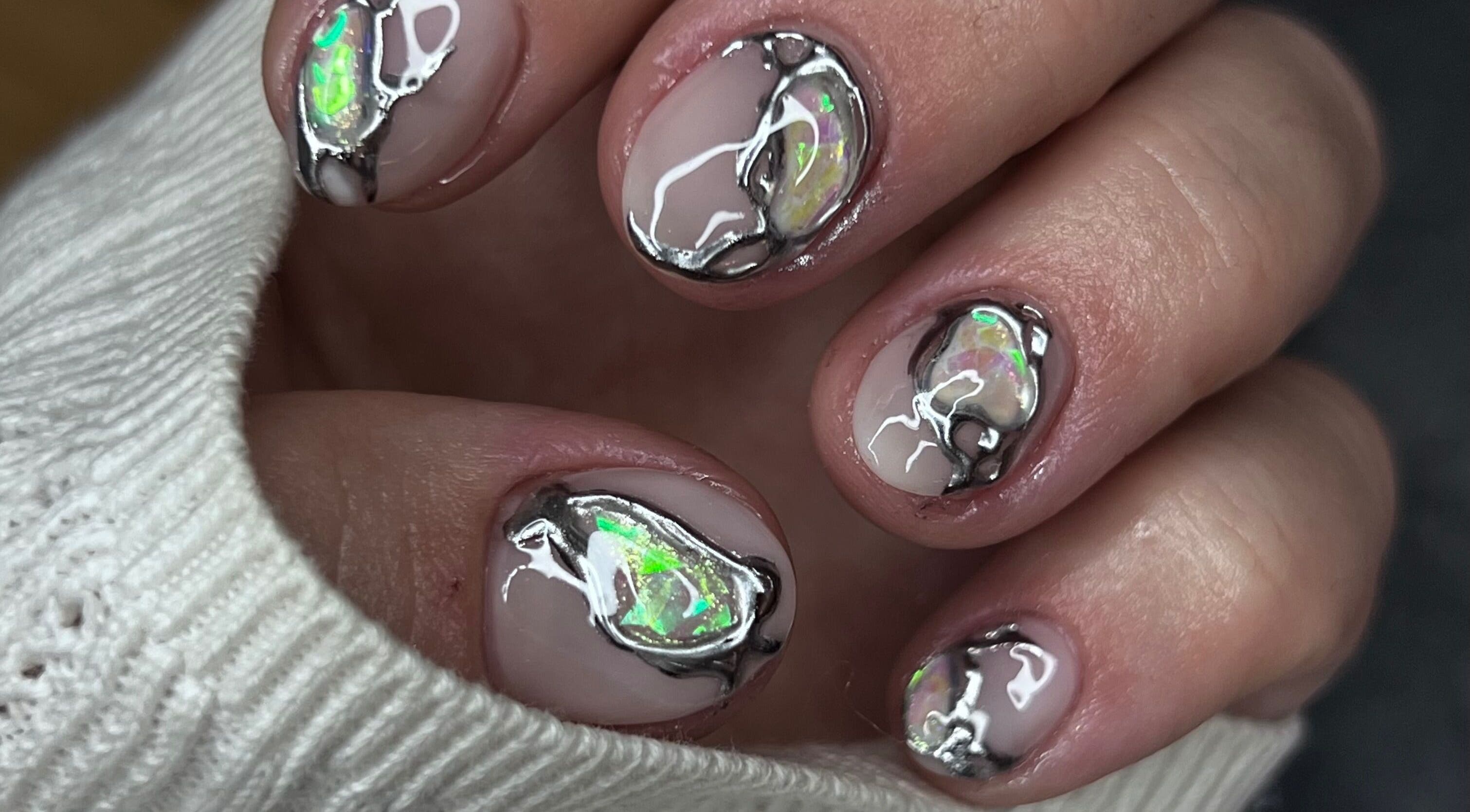 Intricate opal nail art at Puff Polish in Ottawa, Ontario, CA, showcasing shimmering design detail.