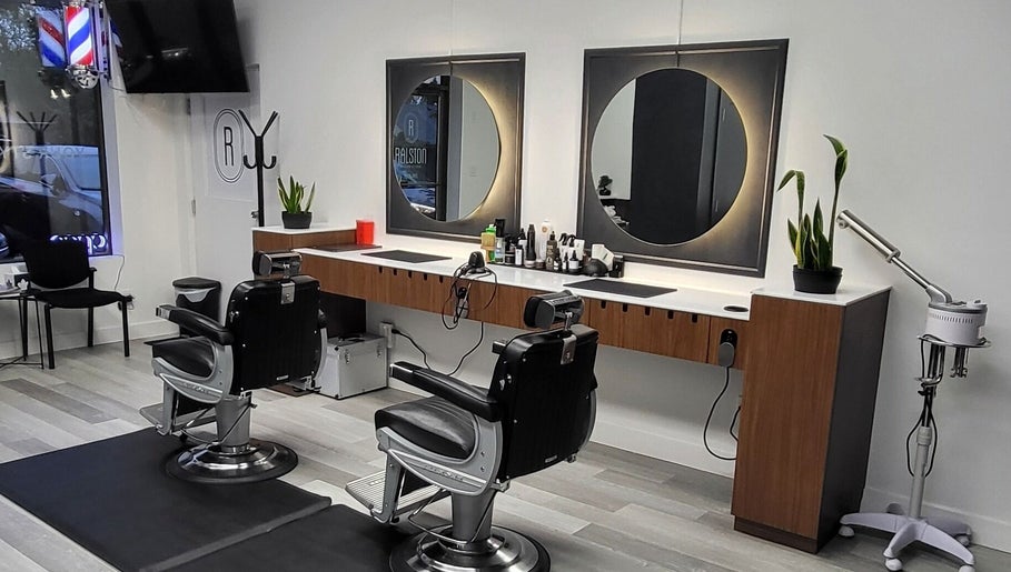 Modern barber stations at Ralston Barber Studio, Mississauga, Ontario, CA, featuring sleek chairs and mirrors.