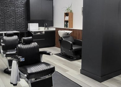 Interior view of Ralston Barber Studio in Mississauga, Ontario, CA with modern black leather barber chairs.