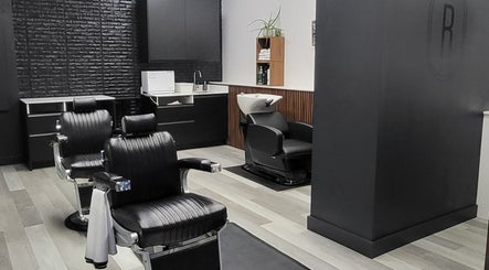 Interior view of Ralston Barber Studio in Mississauga, Ontario, CA with modern black leather barber chairs.