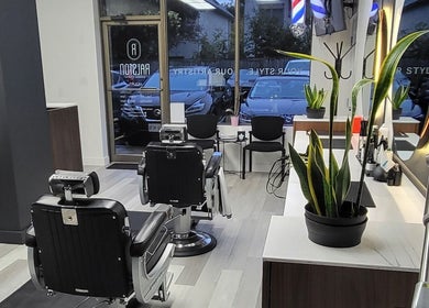 Cozy interior of Ralston Barber Studio in Mississauga, Ontario, CA with modern barber chairs and decor.