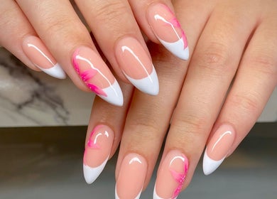Elegant nail design at Nail Oasis, Pukekohe, Auckland, NZ featuring pink and white floral patterns.