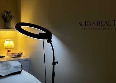 Cozy Sildasbeauty treatment room with soft lighting in London, England, GB.