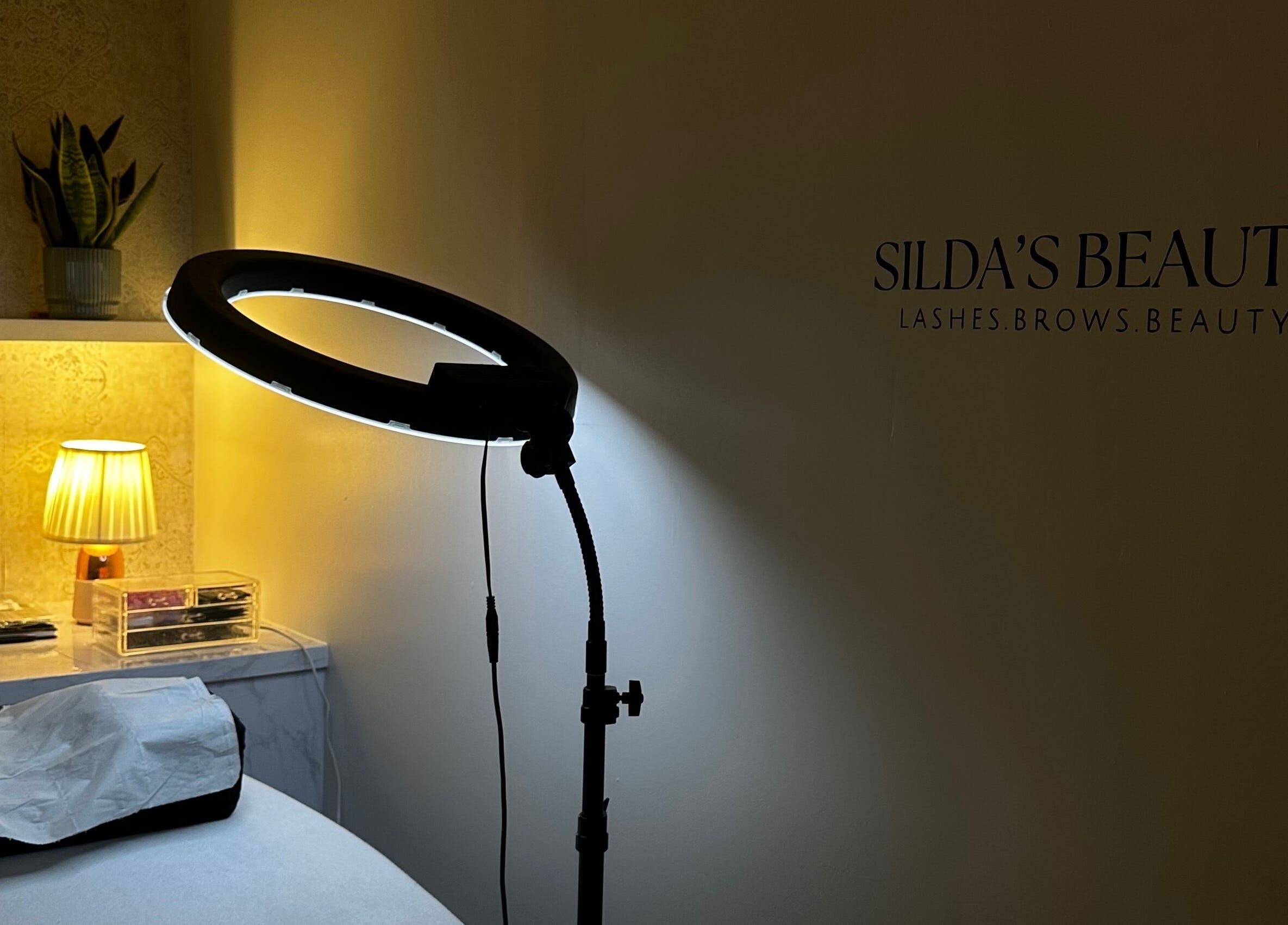 Cozy Sildasbeauty treatment room with soft lighting in London, England, GB.