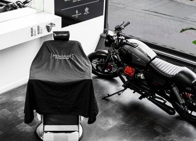 Modern barber chair and sleek motorcycle at MENSPIRE Old West, Amsterdam, Noord-Holland, NL.