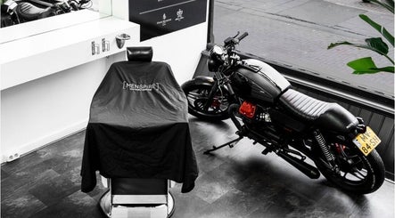 Modern barber chair and sleek motorcycle at MENSPIRE Old West, Amsterdam, Noord-Holland, NL.