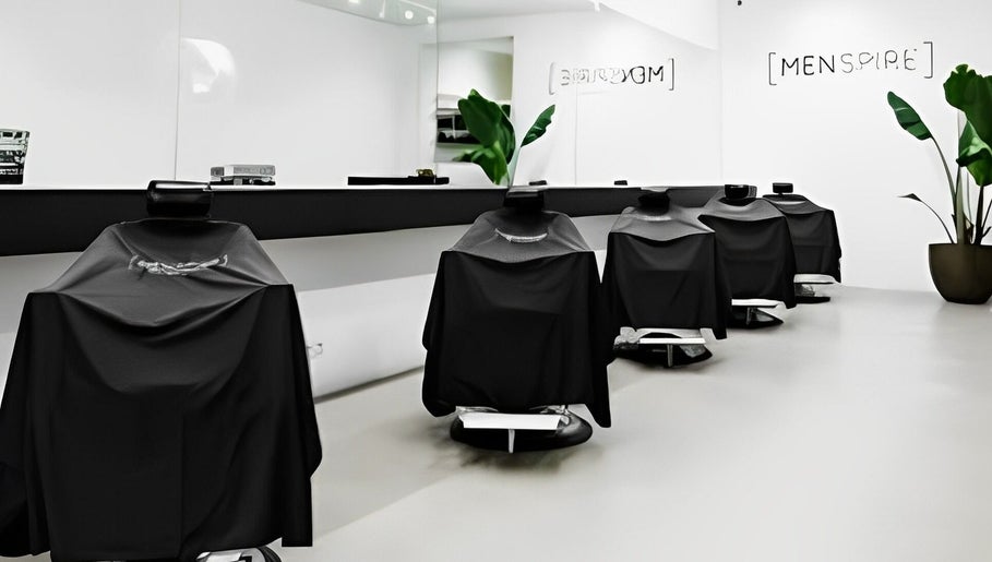 Modern barber chairs at MENSPIRE De Pijp, Amsterdam, Noord-Holland, NL offering stylish grooming services.