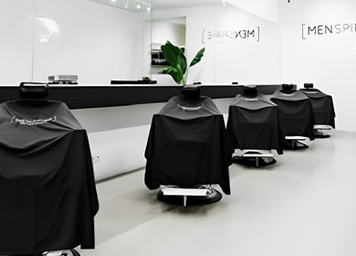 Modern barber chairs at MENSPIRE De Pijp, Amsterdam, Noord-Holland, NL offering stylish grooming services.