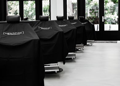 Chic black salon chairs at MENPSIRE Beethoven, Amsterdam, Noord-Holland, NL, exuding modern elegance.