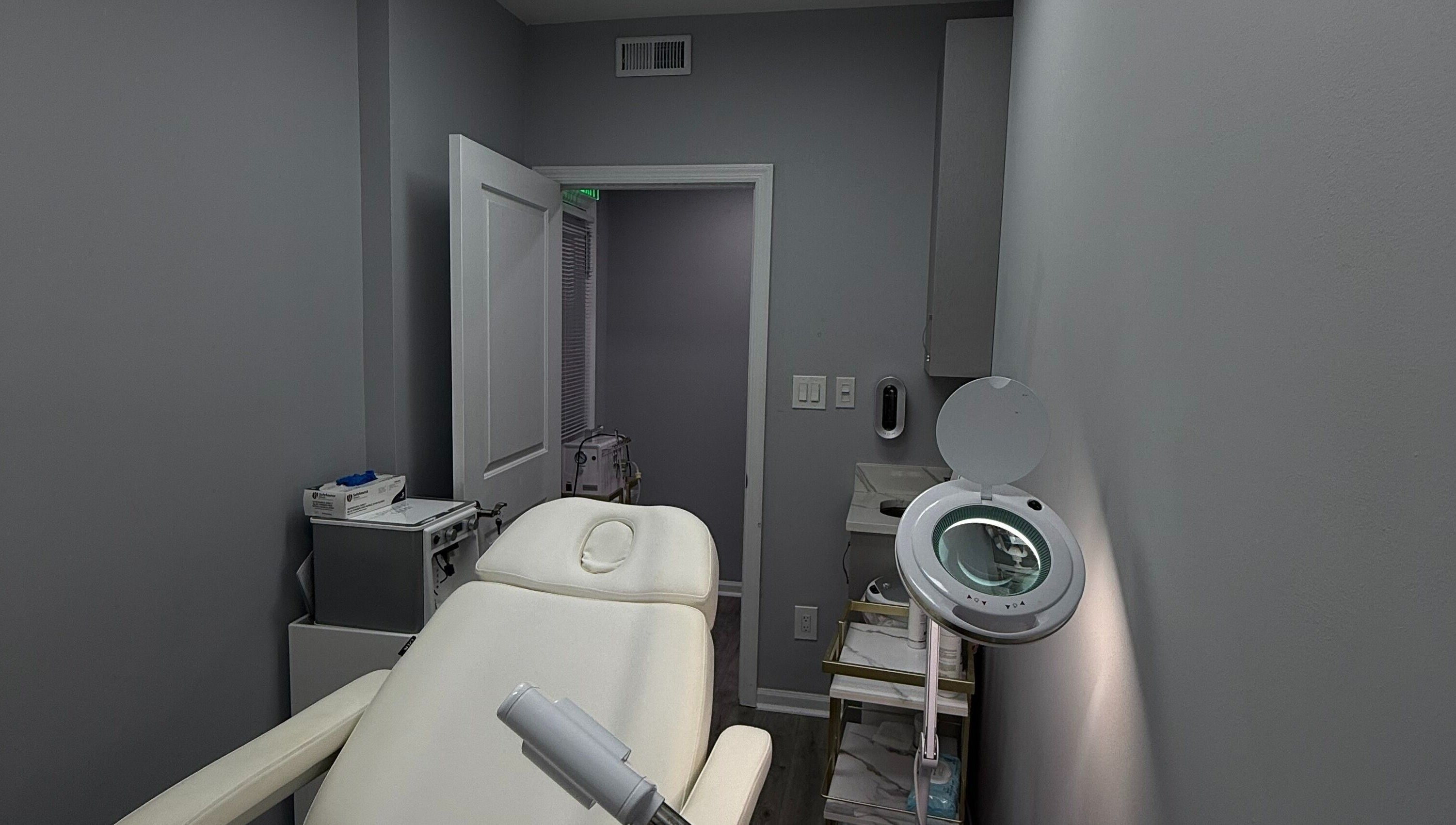 Tranquil treatment room at Injectables NYC, New York, New York, US, featuring a plush white chair and sleek decor.