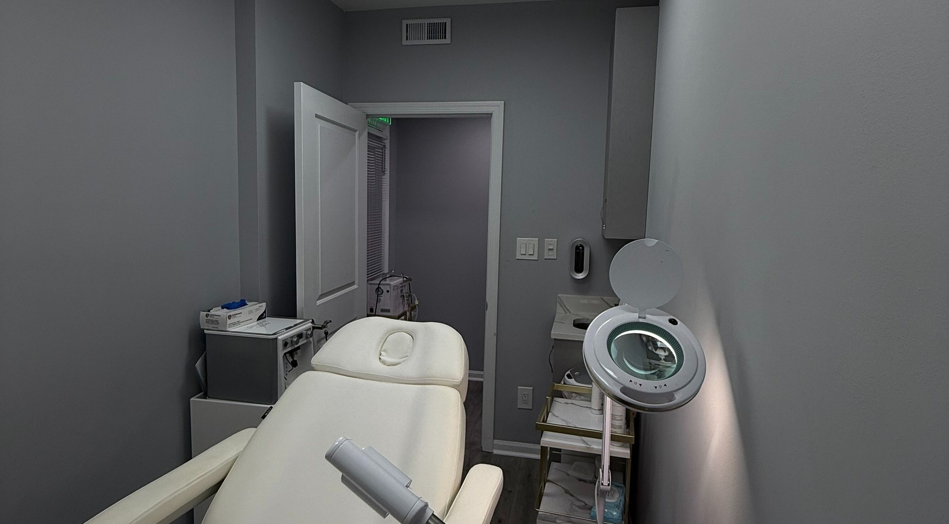 Tranquil treatment room at Injectables NYC, New York, New York, US, featuring a plush white chair and sleek decor.