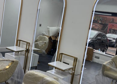 Modern salon mirrors and chairs at Maison La Tresse, Birmingham, England, GB.