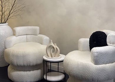 Elegant seating at Maison La Tresse in Birmingham, England. Plush chairs, chic decor create a cozy ambiance.