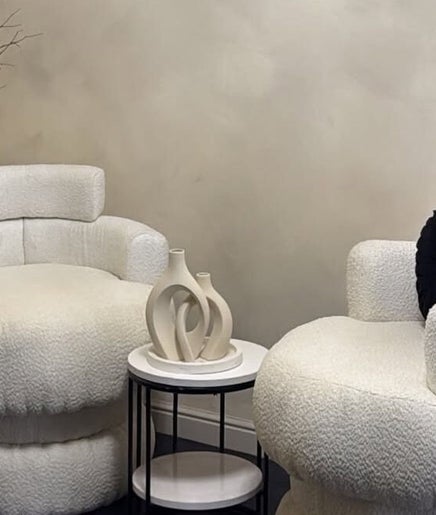 Elegant seating at Maison La Tresse in Birmingham, England. Plush chairs, chic decor create a cozy ambiance.