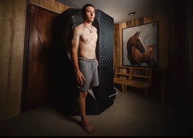 Man standing in cryotherapy chamber at Relab center, Mendoza, Mendoza, AR with horse art on wall.