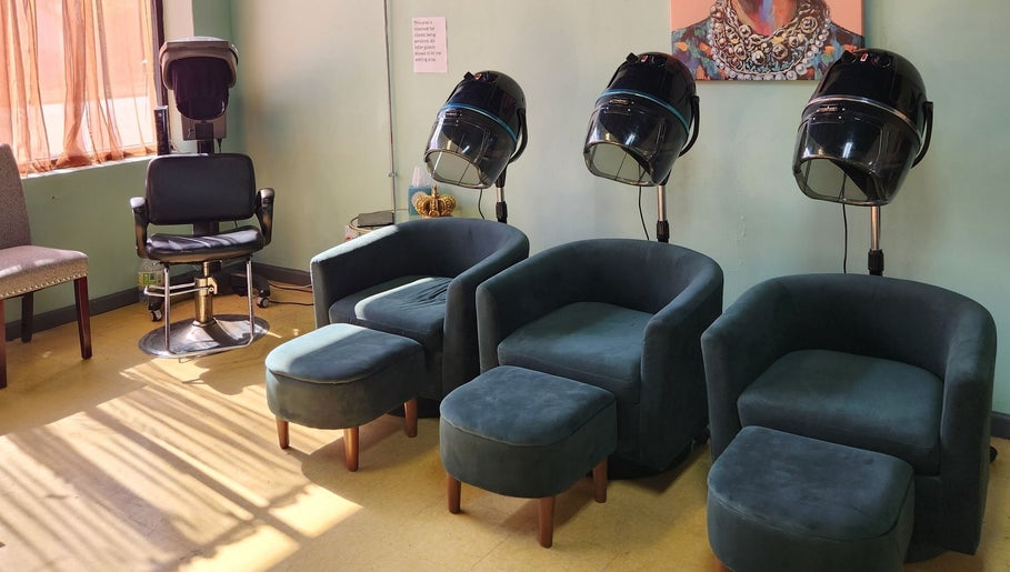 Relaxing seating area at A Different You Salon in Houston, Texas, US, featuring modern salon chairs and hair dryers.