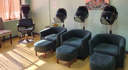 Relaxing seating area at A Different You Salon in Houston, Texas, US, featuring modern salon chairs and hair dryers.