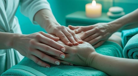 Relaxing hand massage at Natasha & Co Massage, Newton, Massachusetts, US with soothing candlelight.