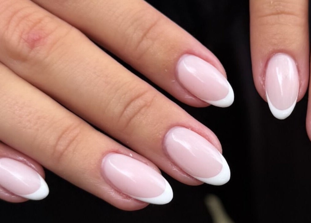 Elegant French manicure nails at Aura Nail Studio, Fairy Meadow, New South Wales, AU.