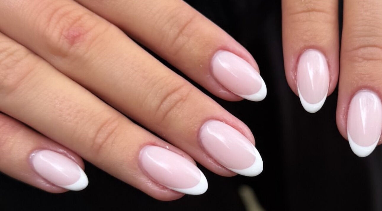 Elegant French manicure nails at Aura Nail Studio, Fairy Meadow, New South Wales, AU.