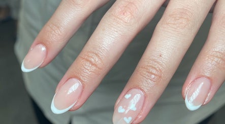 French manicure with heart design at Aura Nail Studio, Fairy Meadow, New South Wales, AU.