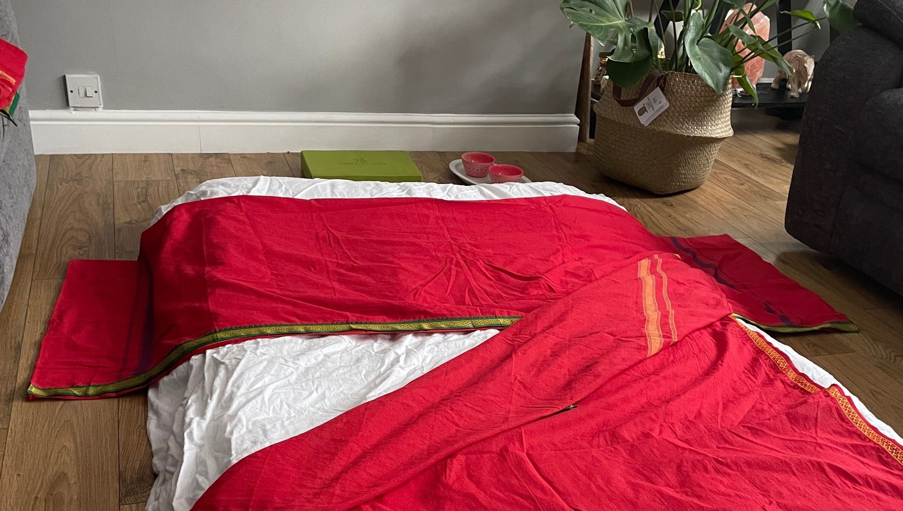 Inviting red massage mat at Northern Glow and Flow, Leeds, England, GB, near lush plant decor.