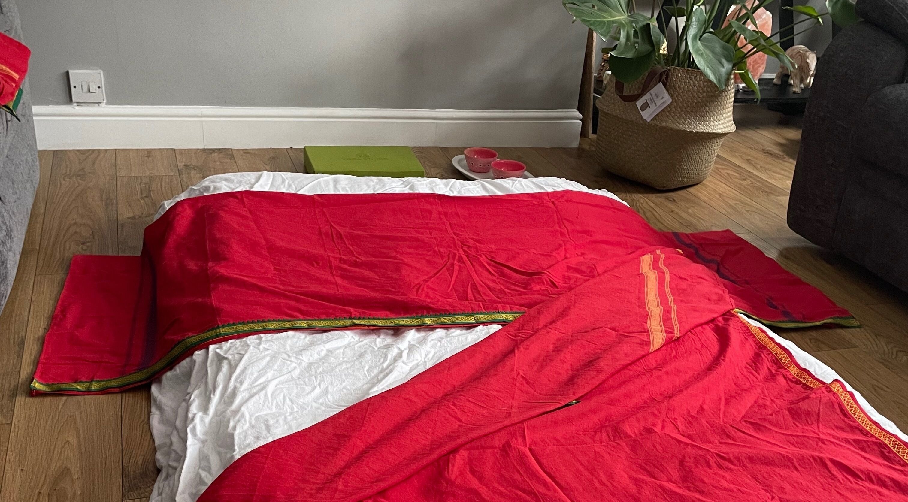 Inviting red massage mat at Northern Glow and Flow, Leeds, England, GB, near lush plant decor.