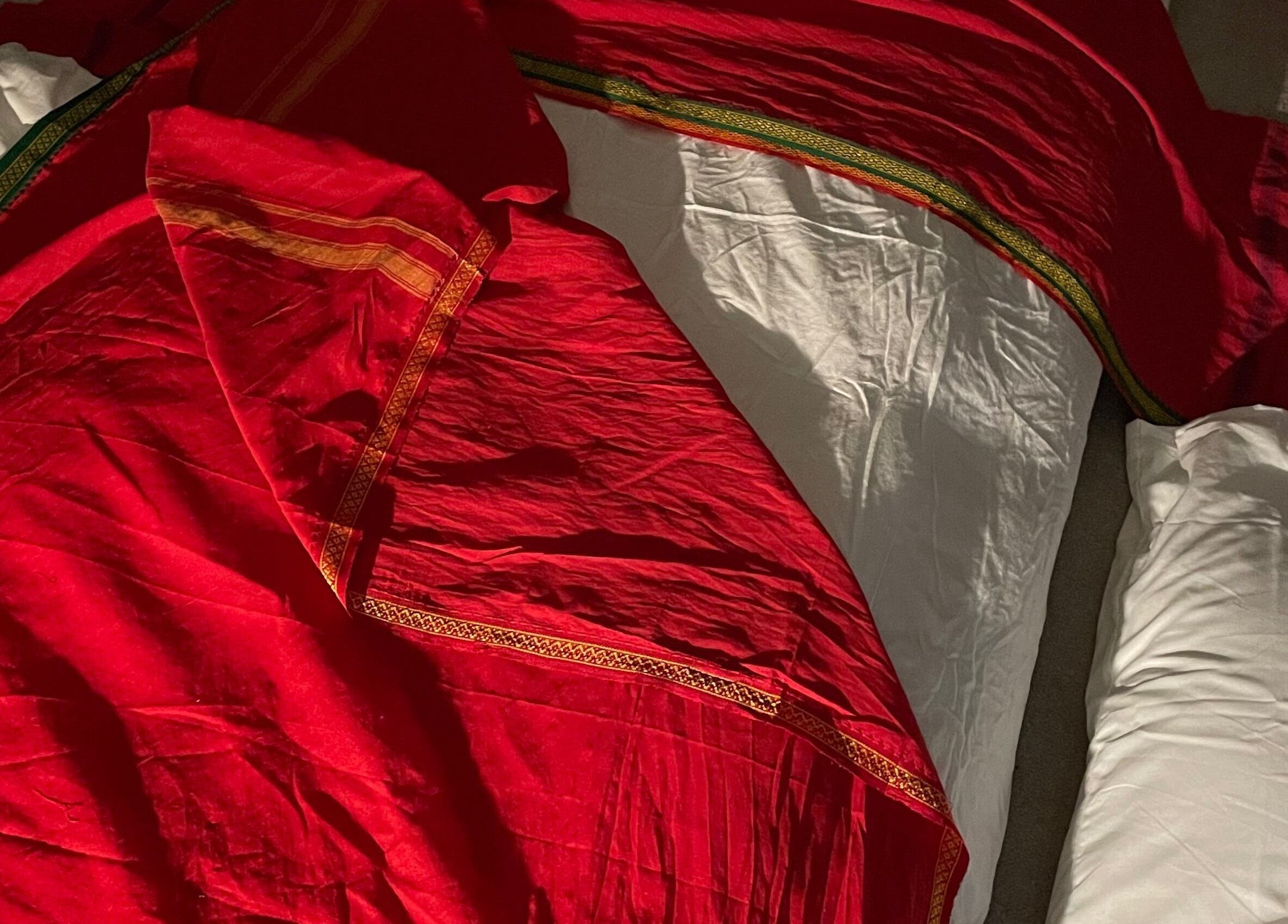 Luxurious red fabric on a massage table at Northern Glow and Flow, Leeds, England, GB.