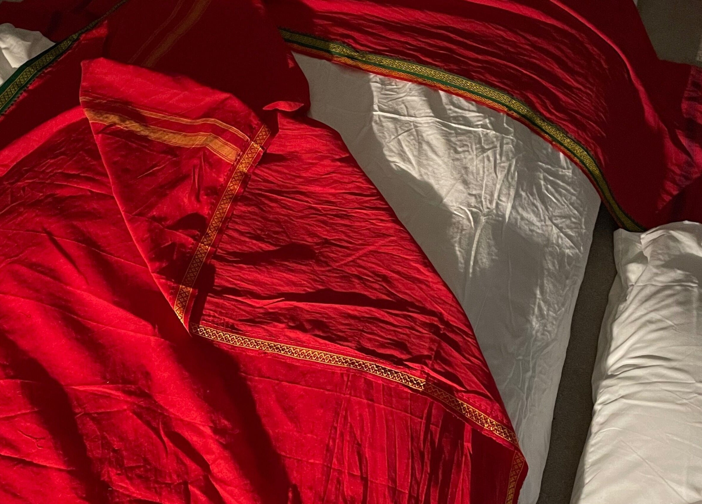 Luxurious red fabric on a massage table at Northern Glow and Flow, Leeds, England, GB.