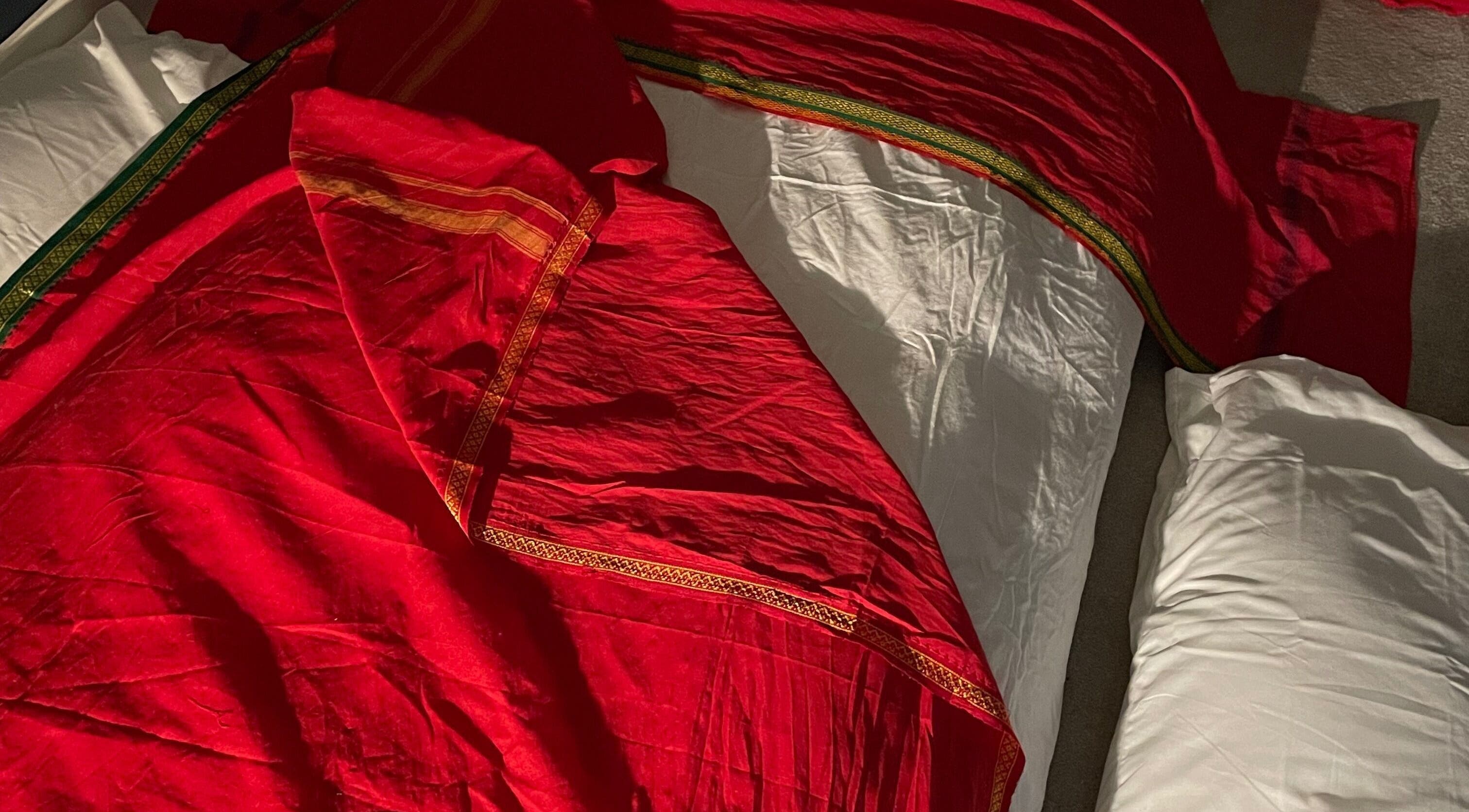 Luxurious red fabric on a massage table at Northern Glow and Flow, Leeds, England, GB.