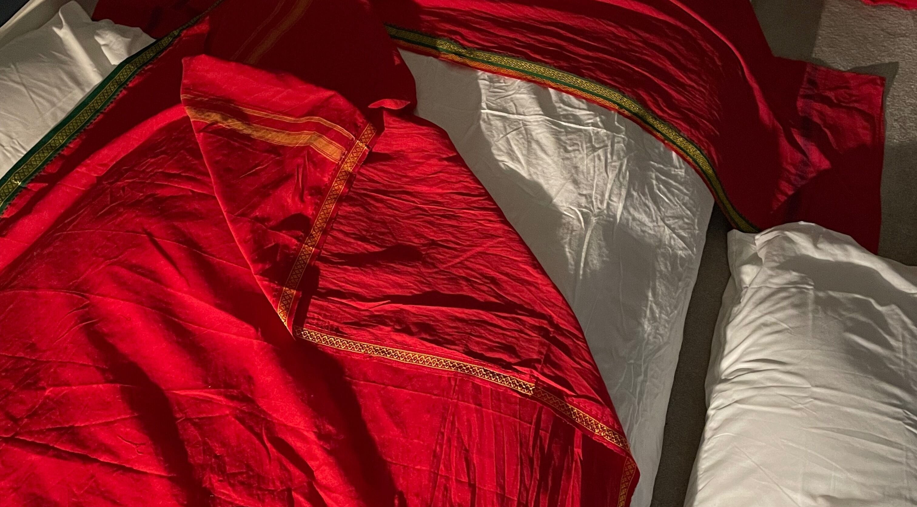 Luxurious red fabric on a massage table at Northern Glow and Flow, Leeds, England, GB.