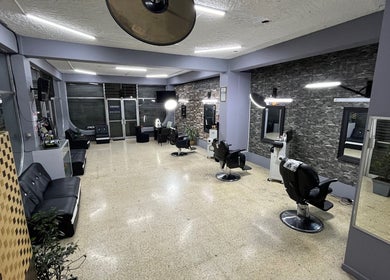 Modern interior of La Barbería at Tres Ríos centro, San José, CR, showcasing sleek barber chairs and stylish decor.