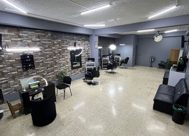 Stylish interior of La Barbería at Tres Ríos centro, San José, CR showcasing modern barber chairs and décor.
