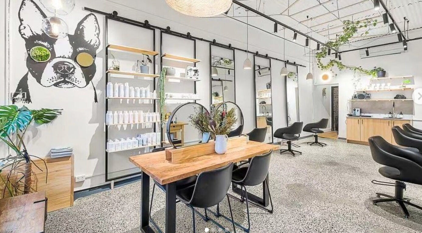 Modern interior of DANIEL DOVE HAIR in Newtown, New South Wales, AU with chic decor and styling stations.