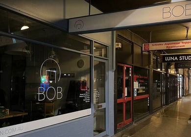 Night view of salon exterior near DANIEL DOVE HAIR, Newtown, New South Wales, AU.