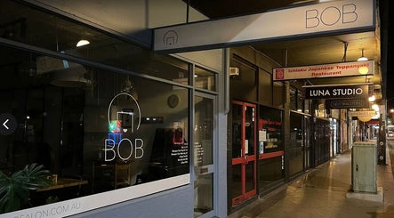 Night view of salon exterior near DANIEL DOVE HAIR, Newtown, New South Wales, AU.