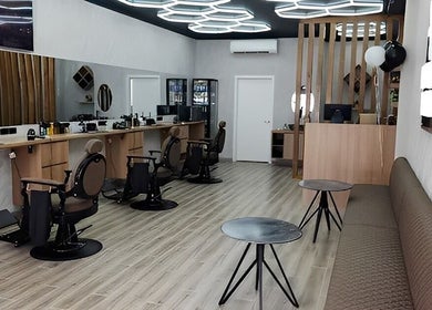 Modern interior of Barbers Vision in Melbourne, Victoria, AU featuring sleek barber chairs and ambient lighting.
