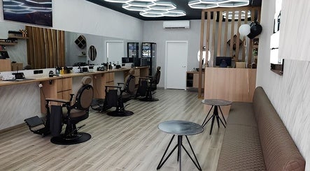 Modern interior of Barbers Vision in Melbourne, Victoria, AU featuring sleek barber chairs and ambient lighting.