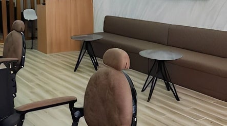 Cozy seating area in Barbers Vision, Melbourne, Victoria, AU with modern chairs and tables.