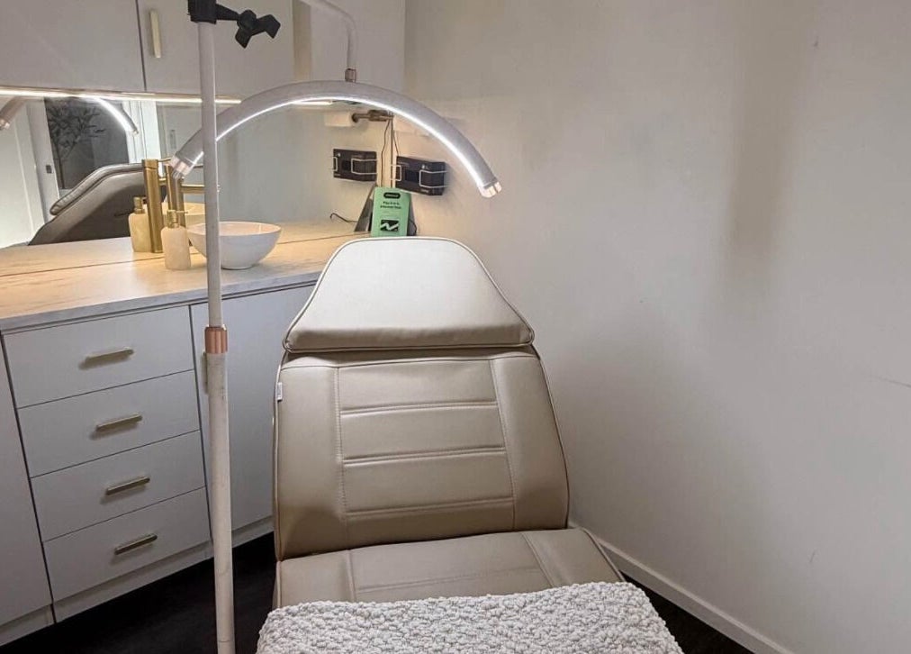 Luxurious treatment room at Harmonii Aesthetics in Mermaid Beach, Queensland, AU featuring a comfy chair.