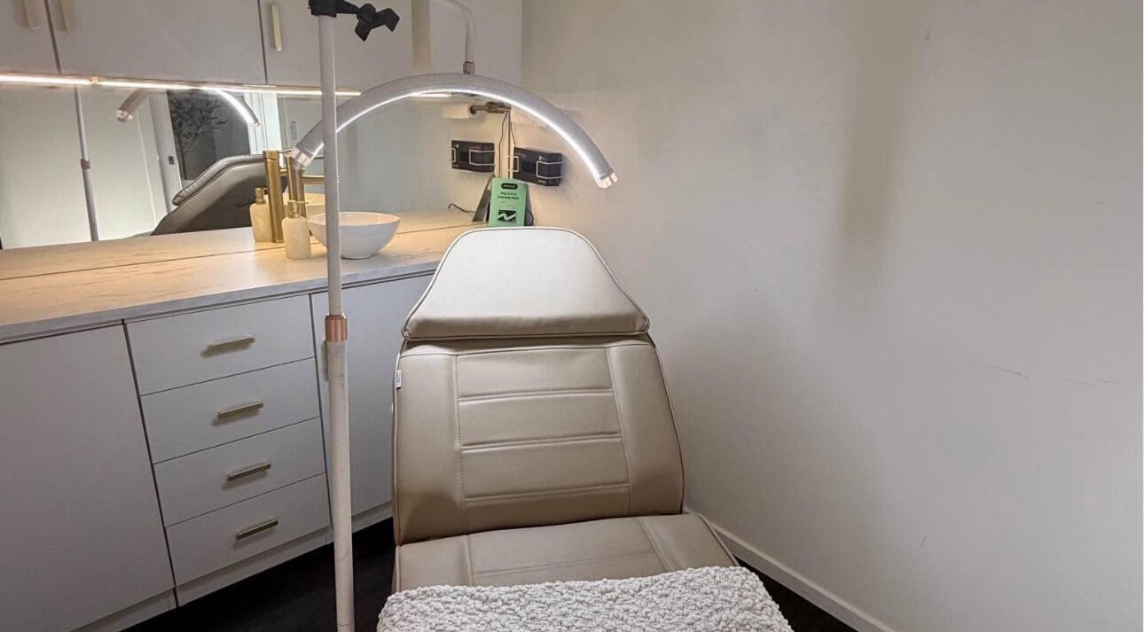 Luxurious treatment room at Harmonii Aesthetics in Mermaid Beach, Queensland, AU featuring a comfy chair.