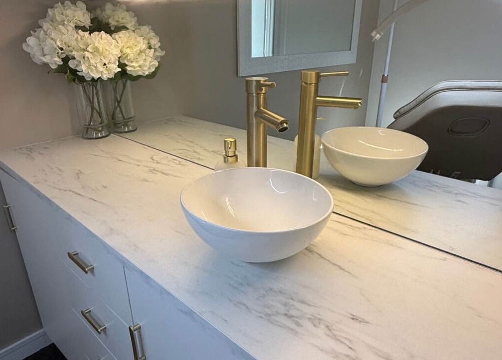 Chic marble vanity with gold fixtures at Harmonii Aesthetics, Mermaid Beach, Queensland, AU for a refined ambiance.